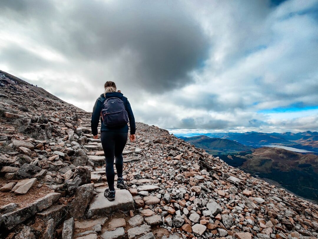 person climbing mountain